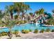 Relaxing lazy river with a waterslide and lush landscaping at 1548 Moon Valley Dr, Davenport, FL 33896