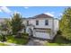 Two-story home with white exterior and gray roof at 1548 Moon Valley Dr, Davenport, FL 33896