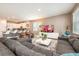 Open concept living room with sectional sofa and kitchen view at 1548 Moon Valley Dr, Davenport, FL 33896
