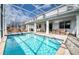 Screened pool and spa with lounge chairs at 1548 Moon Valley Dr, Davenport, FL 33896