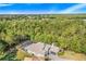 Aerial view of single-Gathering home with pool and screened enclosure in wooded setting at 2857 Atherton Dr, Orlando, FL 32824