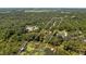 Aerial view showcasing a waterfront property with a long driveway and lush surroundings at 10611 Jim Edwards Rd, Haines City, FL 33844
