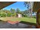 Landscaped backyard with a shed and water view at 10611 Jim Edwards Rd, Haines City, FL 33844