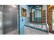 Retro bathroom with blue tile, shower and vanity at 10611 Jim Edwards Rd, Haines City, FL 33844