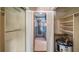 Bathroom with shower, storage, and water heater at 10611 Jim Edwards Rd, Haines City, FL 33844