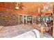 Bedroom with log bed frame and access to screened porch at 10611 Jim Edwards Rd, Haines City, FL 33844