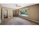 Carpeted bedroom with window and access to bathroom at 10611 Jim Edwards Rd, Haines City, FL 33844