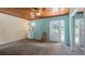 Bedroom with wood ceilings, a small vanity, and access to the outdoors at 10611 Jim Edwards Rd, Haines City, FL 33844