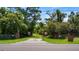 Private gated entrance with brick pillars and a paved driveway at 10611 Jim Edwards Rd, Haines City, FL 33844