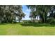 Serene lakefront property with lush landscaping and a dock at 10611 Jim Edwards Rd, Haines City, FL 33844