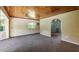 Open living area with wood ceilings and carpeted floors at 10611 Jim Edwards Rd, Haines City, FL 33844