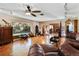 Spacious living room with hardwood floors, large windows, and a view of the backyard at 10611 Jim Edwards Rd, Haines City, FL 33844