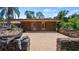 Stone patio with double doors leading inside at 10611 Jim Edwards Rd, Haines City, FL 33844