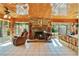 Sunroom with stone fireplace and wood-paneled ceiling at 10611 Jim Edwards Rd, Haines City, FL 33844