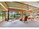 Sunroom with large windows, wooden ceiling, and comfortable seating area at 10611 Jim Edwards Rd, Haines City, FL 33844