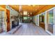 Sunroom with stone fireplace and wood-paneled walls at 10611 Jim Edwards Rd, Haines City, FL 33844
