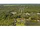 Aerial view showcasing waterfront property with dock access and lush surroundings at 10611 Jim Edwards Rd, Haines City, FL 33844