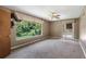 Bedroom with large windows, carpet flooring, and access to patio at 10611 Jim Edwards Rd, Haines City, FL 33844