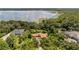 Aerial view of house on lakefront property with lush landscaping and other homes visible at 10611 Jim Edwards Rd, Haines City, FL 33844