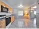 Bright kitchen featuring wood cabinets, tile floors, and modern appliances at 7685 Ceres Dr, Orlando, FL 32822