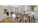 Bright dining area with a modern table and chairs, hardwood floors, and an open concept at 7524 Seurat St # 12301, Orlando, FL 32819