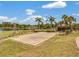 Sand volleyball court with lake view and lush landscaping at 7524 Seurat St # 12301, Orlando, FL 32819