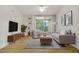 Living room features hardwood floors, neutral walls, and ample natural light at 7524 Seurat St # 12301, Orlando, FL 32819