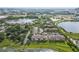 Aerial view of lakefront apartment community with lush landscaping and parking at 7524 Seurat St # 12301, Orlando, FL 32819
