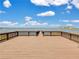 Lakefront view from a wooden deck, offering serene waterfront access at 7524 Seurat St # 12301, Orlando, FL 32819