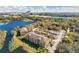 Aerial view of a community with lakefront property, lush landscaping, and convenient parking at 7524 Seurat St # 12301, Orlando, FL 32819