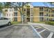 Building exterior with ample parking and landscaping at 7524 Seurat St # 12301, Orlando, FL 32819