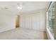 Well-lit bedroom featuring a double door closet and window at 7524 Seurat St # 12301, Orlando, FL 32819