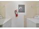 Laundry room with full-size washer and dryer and shelving at 7524 Seurat St # 12301, Orlando, FL 32819