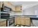 Kitchen boasts stainless steel appliances and light wood cabinets at 7524 Seurat St # 12301, Orlando, FL 32819
