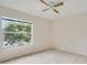 Bright bedroom with large window and neutral carpeting at 7524 Seurat St # 12301, Orlando, FL 32819