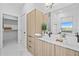 Double vanity bathroom with light wood cabinets and marble countertops at 6311 Chorus Dr, Mascotte, FL 34753