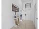 Modern entryway with a gold console table, decor, and white door at 6311 Chorus Dr, Mascotte, FL 34753