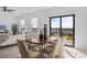 Bright dining area with wooden table, six chairs, and sliding doors leading to backyard at 6311 Chorus Dr, Mascotte, FL 34753