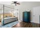 Large main bedroom with a canopy bed and dark wood floors at 570 Pinebranch Cir, Winter Springs, FL 32708