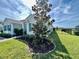 Side view of a light teal house with landscaping at 16744 Sanctuary Dr, Winter Garden, FL 34787