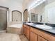 Elegant bathroom with a large soaking tub, double vanity, and walk-in shower at 13333 Early Frost Cir, Orlando, FL 32828