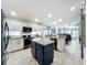 Modern kitchen with stainless steel appliances, white cabinets, and a large kitchen island at 13333 Early Frost Cir, Orlando, FL 32828