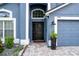 House exterior with blue painted walls and a black door at 13333 Early Frost Cir, Orlando, FL 32828