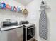 Laundry room with washer, dryer, and shelving for storage at 13333 Early Frost Cir, Orlando, FL 32828