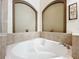 Corner bathtub with tile surround in a clean bathroom at 13333 Early Frost Cir, Orlando, FL 32828