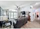 Bright living room with hardwood floors, comfortable seating, and an entertainment center at 13333 Early Frost Cir, Orlando, FL 32828