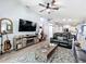 Open living space with a large TV, comfortable seating, and views into the kitchen and dining area at 13333 Early Frost Cir, Orlando, FL 32828