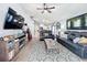 Living room with open floor plan, leather furniture and a view to the kitchen at 13333 Early Frost Cir, Orlando, FL 32828