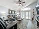 Relaxing living room with leather seating, a large TV, and access to a back patio at 13333 Early Frost Cir, Orlando, FL 32828