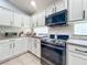Modern kitchen with stainless steel appliances and white cabinets at 13333 Early Frost Cir, Orlando, FL 32828